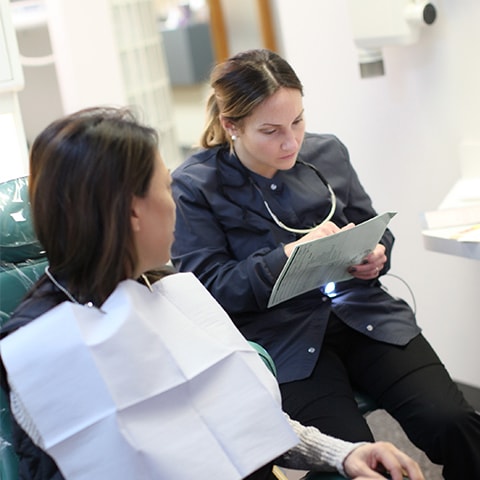 Team member of KB Dental making a dental plan with a patient