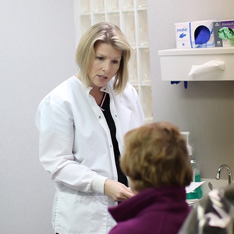 A team member of KB Dental is listening with concern to a patient